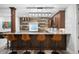 Stylish home bar with wood accents, open shelving, and seating for four at 2821 E Cedar Ave # 2, Denver, CO 80209