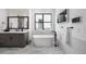Bright bathroom showcasing a soaking tub, gray vanity, and sleek black fixtures at 2821 E Cedar Ave # 2, Denver, CO 80209