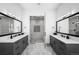 Symmetrical primary bath featuring dual vanities, modern tile, and a glass shower at 2821 E Cedar Ave # 2, Denver, CO 80209