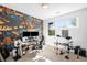 A music themed bedroom with computer and instruments provides a creative space filled with color and inspiration at 2821 E Cedar Ave # 2, Denver, CO 80209