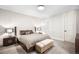 This cozy bedroom is styled with an upholstered headboard, accent lamps, and neutral colors at 2821 E Cedar Ave # 2, Denver, CO 80209