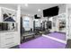 Bright home gym features mirrored walls, rubber flooring, workout equipment, and storage for towels and weights at 2821 E Cedar Ave # 2, Denver, CO 80209