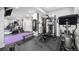 The home gym is equipped with a range of equipment, including weights and cardio machines, on a rubber floor at 2821 E Cedar Ave # 2, Denver, CO 80209