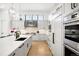 Modern kitchen with a large island, stylish backsplash, and top-of-the-line stainless steel appliances at 2821 E Cedar Ave # 2, Denver, CO 80209