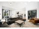 Open-concept living area with kitchen, modern furnishings, and lots of natural light at 2821 E Cedar Ave # 2, Denver, CO 80209
