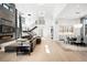 Open-concept design with fireplace, sleek staircase, modern lighting, and bright living area at 2821 E Cedar Ave # 2, Denver, CO 80209
