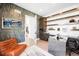 Modern home office with creative shelving, comfortable seating, and decorative wallpaper at 2821 E Cedar Ave # 2, Denver, CO 80209