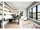 Bright home office featuring custom shelves, modern desk, and large windows with natural light at 2821 E Cedar Ave # 2, Denver, CO 80209