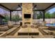 Inviting outdoor living area featuring a stone fireplace, comfortable seating, and elegant design details at 2821 E Cedar Ave # 2, Denver, CO 80209