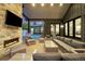 Covered outdoor living space with a stone fireplace, comfortable seating, and views of the pool at 2821 E Cedar Ave # 2, Denver, CO 80209