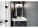 Stylish powder room with black and white textures, modern lighting, and elegant fixtures at 2821 E Cedar Ave # 2, Denver, CO 80209