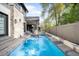Luxurious swimming pool and spa with stone accents and an outdoor living area in a serene backyard setting at 2821 E Cedar Ave # 2, Denver, CO 80209