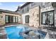 Outdoor pool and spa area with stone accents and French doors, offering luxurious backyard experience at 2821 E Cedar Ave # 2, Denver, CO 80209