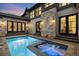 Swimming pool and spa area with stone accents and elegant outdoor lighting on a modern home at 2821 E Cedar Ave # 2, Denver, CO 80209