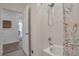 Updated bathroom with tiled shower, white walls and door leading to the rest of the home at 16841 Askins Loop # 101, Parker, CO 80134