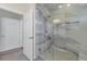 Modern bathroom with a large glass-enclosed shower featuring stylish marble-look tiles and a bench at 16841 Askins Loop # 101, Parker, CO 80134