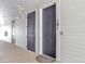 Apartment entryway showcasing unit doors with number 101, white siding, and a welcome mat at 16841 Askins Loop # 101, Parker, CO 80134