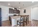 Stylish kitchen features a granite island with seating, dark cabinets, and stainless steel appliances at 16841 Askins Loop # 101, Parker, CO 80134