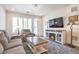 Bright living room with a cozy electric fireplace, neutral-toned furniture, and modern decor at 16841 Askins Loop # 101, Parker, CO 80134