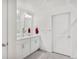 Bright bathroom featuring double sink vanity with white cabinetry, modern fixtures, and tiled flooring at 4125 Marble Dr, Longmont, CO 80504