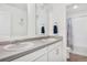 Bright bathroom with double vanity sinks, modern fixtures, and a view into the shower room at 4125 Marble Dr, Longmont, CO 80504