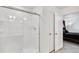 Bathroom with a glass-enclosed shower, tiled walls, white doors and door frames at 4125 Marble Dr, Longmont, CO 80504