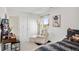 Bedroom with a chaise lounge, window and curtain, bed, and a desk with chair and storage at 4125 Marble Dr, Longmont, CO 80504