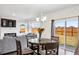 Inviting dining area with a round table, chandelier, and access to the backyard through sliding glass doors at 4125 Marble Dr, Longmont, CO 80504