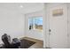 Inviting entryway with a black futon, a window with blinds, and a white front door at 4125 Marble Dr, Longmont, CO 80504