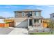 Charming two-story home featuring stone accents, a covered front porch, and a well-maintained landscaped yard at 4125 Marble Dr, Longmont, CO 80504