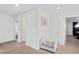 Hallway featuring chair with storage on the seat, white doors and a carpeted floor at 4125 Marble Dr, Longmont, CO 80504