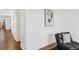 Bright hallway featuring wood floors, white walls and trim, and a decorative piece of artwork at 4125 Marble Dr, Longmont, CO 80504