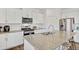 Well-equipped kitchen featuring stainless steel appliances, a granite countertop island, and white cabinetry at 4125 Marble Dr, Longmont, CO 80504