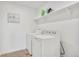Laundry room with shelving above side-by-side washing machine and dryer at 4125 Marble Dr, Longmont, CO 80504