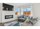 Cozy living room featuring hardwood floors, a fireplace, a flat screen TV and windows providing natural light at 4125 Marble Dr, Longmont, CO 80504