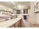 Bathroom featuring a mirrored vanity and wood cabinets at 481 S Kalispell Way # 205, Aurora, CO 80017