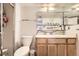 Bathroom features a toilet, vanity with sink, and shower with glass doors at 481 S Kalispell Way # 205, Aurora, CO 80017
