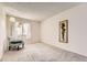 Empty bedroom with plush carpeting, large window and a decorative chair at 481 S Kalispell Way # 205, Aurora, CO 80017
