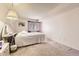 Bedroom showcasing a bed, window with blinds, and a vanity at 481 S Kalispell Way # 205, Aurora, CO 80017
