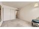 Neutral bedroom features carpet, closet and decorative chair at 481 S Kalispell Way # 205, Aurora, CO 80017