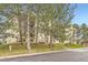 Apartment building surrounded by mature trees, green space, and accessible by sidewalk and street at 481 S Kalispell Way # 205, Aurora, CO 80017