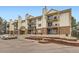 Multi-level condo building boasting private balconies and brick accents near parking area at 481 S Kalispell Way # 205, Aurora, CO 80017