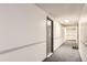 View of an empty hallway with neutral decor, wall trim and gray carpet outside unit 205 at 481 S Kalispell Way # 205, Aurora, CO 80017