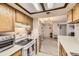 Open kitchen view with wooden cabinets and connection to living space at 481 S Kalispell Way # 205, Aurora, CO 80017