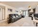 Living room featuring a stone fireplace, comfortable seating, and bright natural light at 481 S Kalispell Way # 205, Aurora, CO 80017