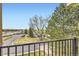 Balcony view of parking lot, building, trees, and clear blue sky from upper-level apartment at 481 S Kalispell Way # 205, Aurora, CO 80017