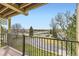 Upper balcony overlooking a street, parking lot, building, and trees on a clear day at 481 S Kalispell Way # 205, Aurora, CO 80017