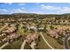 Stunning aerial view of the community, showcasing the homes, lake and lush landscaping at 5069 Castle Pines S Dr, Castle Rock, CO 80108