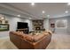 Cozy basement living area with a stone fireplace, comfortable seating, and natural light at 5069 Castle Pines S Dr, Castle Rock, CO 80108