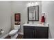 Stylish powder room featuring a modern vanity, framed mirror, and elegant decor at 5069 Castle Pines S Dr, Castle Rock, CO 80108